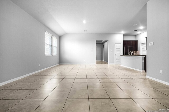 12466 Belfort Pt, Schertz, TX 78154 - unfurnished living room with light tile patterned floors, recessed lighting, baseboards, and lofted ceiling