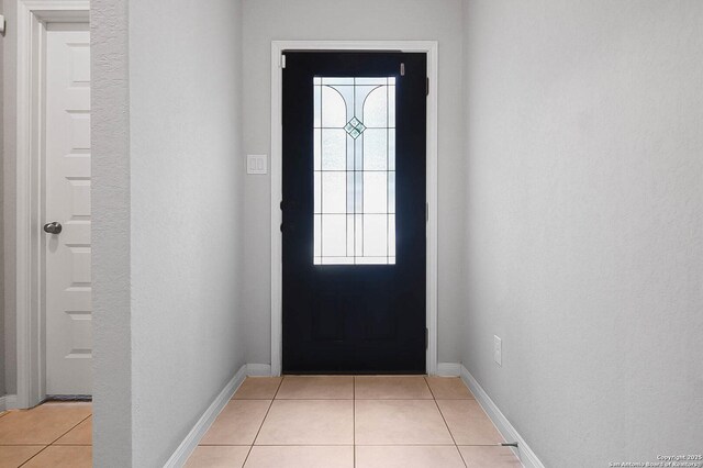 12466 Belfort Pt, Schertz, TX 78154 - doorway to outside with light tile patterned floors and baseboards