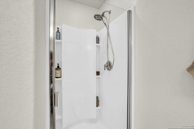 3628 Lazy Diamond, Selma, TX 78154 - full bathroom with a stall shower and a textured wall