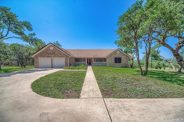 ranch-style house featuring an attached garage, concrete driveway, a front yard, and a tile roof