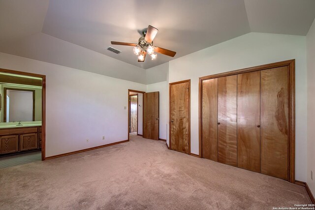 2721 Barton Hl, Bulverde, TX 78163 - unfurnished bedroom with carpet, multiple closets, vaulted ceiling, a sink, and baseboards