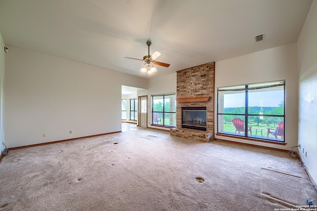 2721 Barton Hl, Bulverde, TX 78163 - unfurnished living room featuring carpet, ceiling fan, baseboards, and a brick fireplace
