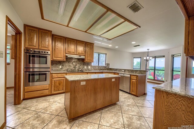2721 Barton Hl, Bulverde, TX 78163 - kitchen featuring stainless steel appliances, under cabinet range hood, a peninsula, a center island, and tasteful backsplash
