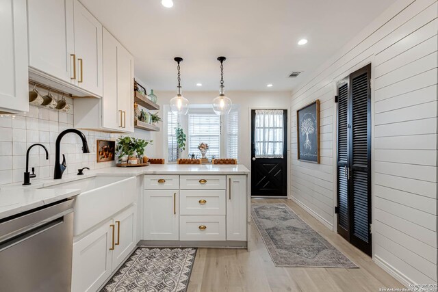 7500 Callaghan Rd Unit 108, San Antonio, TX 78229 - kitchen with dishwasher, a peninsula, light wood finished floors, recessed lighting, and white cabinets