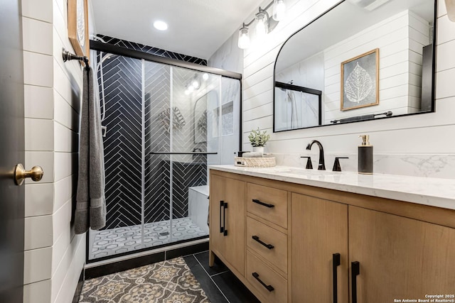 7500 Callaghan Rd Unit 108, San Antonio, TX 78229 - bathroom with vanity, a stall shower, tile patterned flooring, and recessed lighting