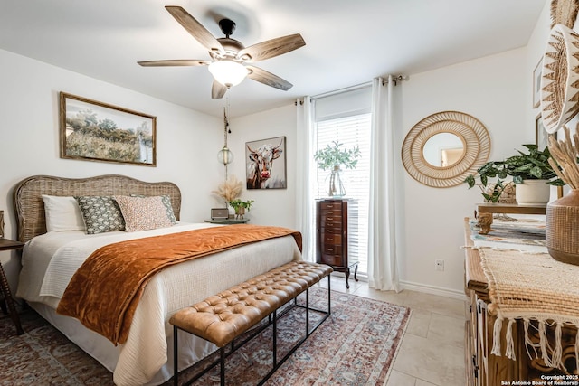 7500 Callaghan Rd Unit 108, San Antonio, TX 78229 - bedroom with light tile patterned floors, baseboards, and a ceiling fan