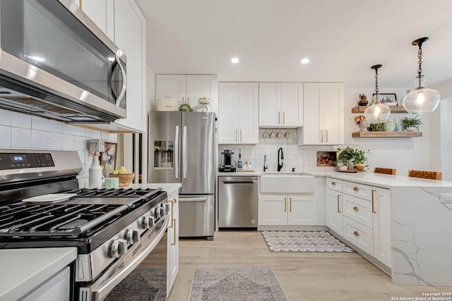 7500 Callaghan Rd Unit 108, San Antonio, TX 78229 - kitchen featuring appliances with stainless steel finishes, tasteful backsplash, white cabinetry, a sink, and open shelves