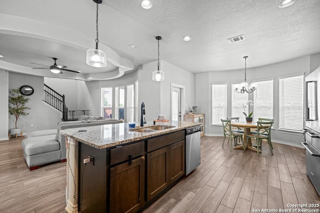 8502 Kallison Arbor, San Antonio, TX 78254 - kitchen with appliances with stainless steel finishes, a sink, baseboards, light wood-type flooring, and a textured ceiling