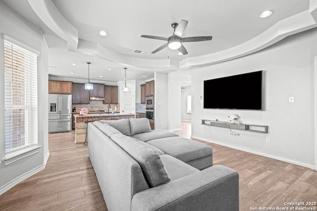 8502 Kallison Arbor, San Antonio, TX 78254 - living room featuring recessed lighting, arched walkways, ceiling fan, light wood-style floors, and baseboards