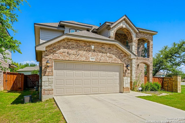 8502 Kallison Arbor, San Antonio, TX 78254 - view of front of home featuring a balcony, driveway, a gate, a garage, and stone siding
