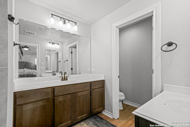 8502 Kallison Arbor, San Antonio, TX 78254 - ensuite bathroom with vanity, toilet, wood finished floors, and baseboards