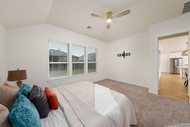 2230 Bennett Ave, New Braunfels, TX 78132 - bedroom featuring freestanding refrigerator, light carpet, baseboards, vaulted ceiling, and ceiling fan