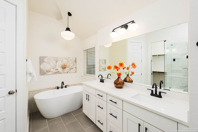 2230 Bennett Ave, New Braunfels, TX 78132 - bathroom with tile patterned floors, lofted ceiling, a freestanding bath, double vanity, and a stall shower