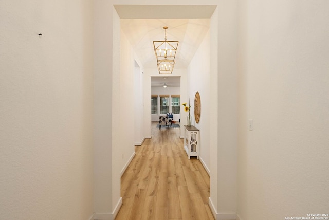 2230 Bennett Ave, New Braunfels, TX 78132 - hallway with a chandelier, light wood-type flooring, and baseboards