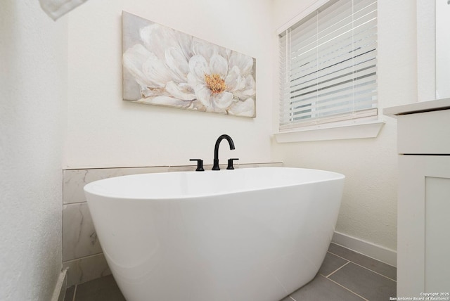 2230 Bennett Ave, New Braunfels, TX 78132 - full bathroom with a freestanding bath, tile patterned floors, and baseboards