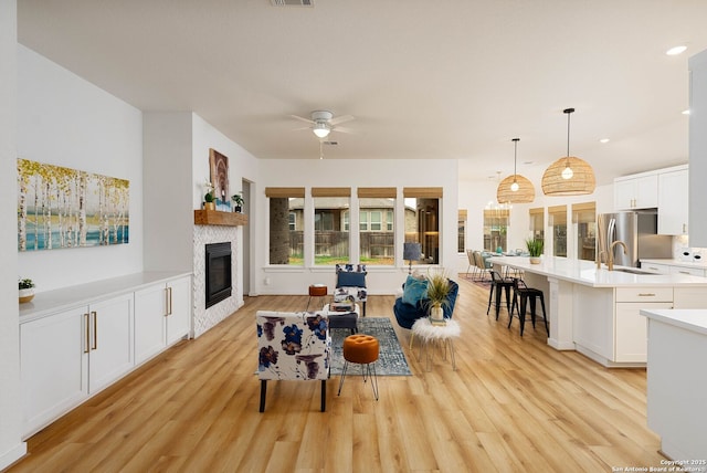 2230 Bennett Ave, New Braunfels, TX 78132 - living room with a ceiling fan, light wood-type flooring, a glass covered fireplace, and recessed lighting