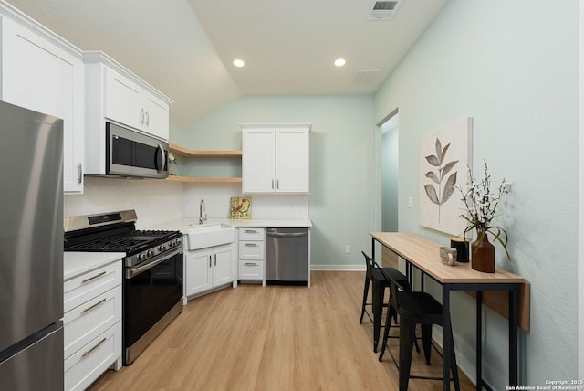 2230 Bennett Ave, New Braunfels, TX 78132 - kitchen featuring stainless steel appliances, a sink, light countertops, white cabinetry, and light wood-type flooring