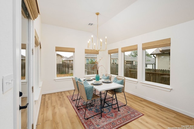 2230 Bennett Ave, New Braunfels, TX 78132 - dining room with light wood-style floors, a chandelier, plenty of natural light, baseboards, and lofted ceiling