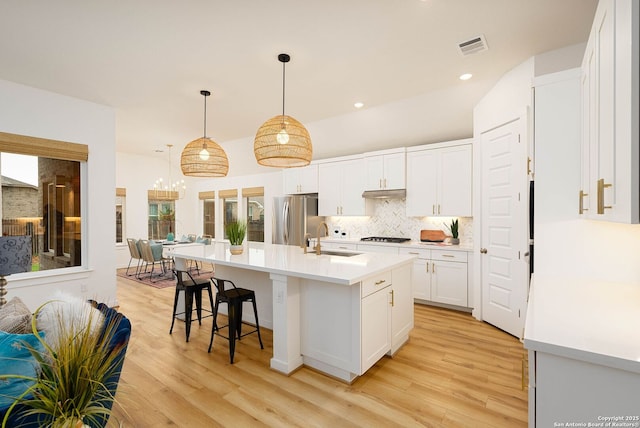2230 Bennett Ave, New Braunfels, TX 78132 - kitchen featuring freestanding refrigerator, a sink, light wood-style floors, white cabinets, and recessed lighting