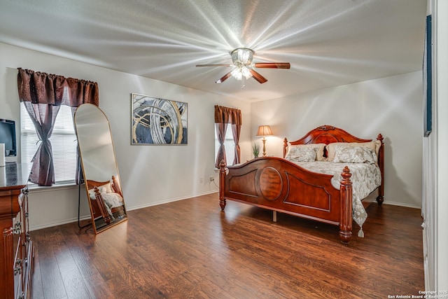 bedroom with wood finished floors, a ceiling fan, and baseboards
