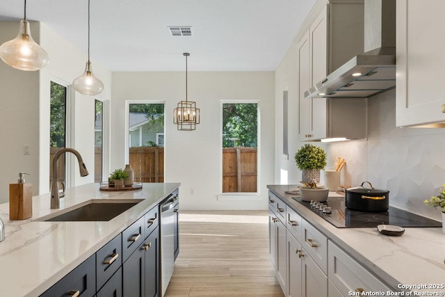 1310 S Mesquite, San Antonio, TX 78210 - kitchen with wall chimney range hood, a sink, black electric stovetop, and healthy amount of natural light