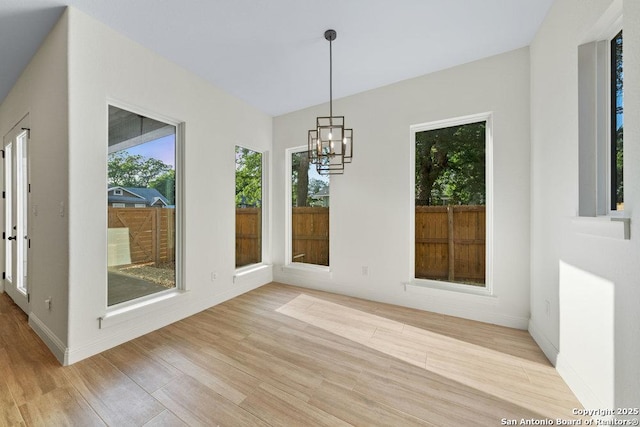 1310 S Mesquite, San Antonio, TX 78210 - unfurnished dining area with light wood-style floors, a chandelier, and baseboards