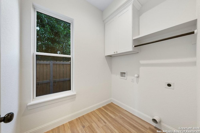 1310 S Mesquite, San Antonio, TX 78210 - laundry room featuring electric dryer hookup, light wood-type flooring, cabinet space, baseboards, and washer hookup