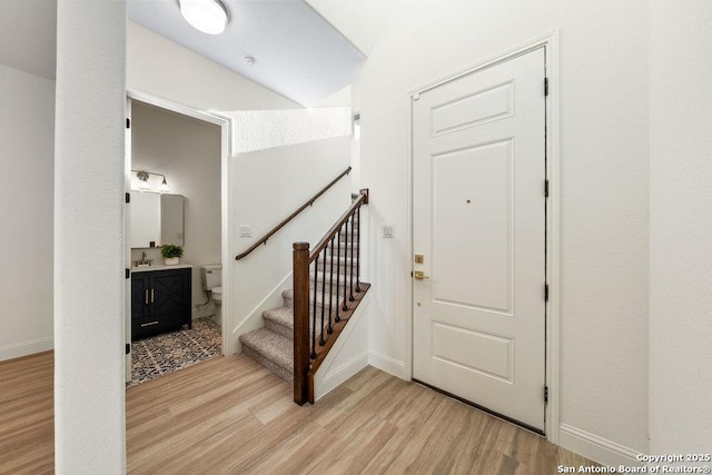 1310 S Mesquite, San Antonio, TX 78210 - entryway featuring light wood-type flooring, baseboards, and stairs