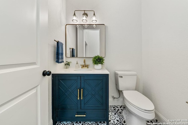 1310 S Mesquite, San Antonio, TX 78210 - bathroom with toilet, baseboards, and vanity