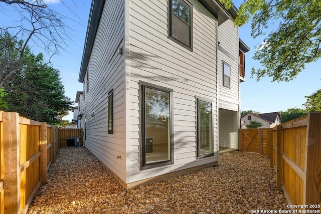 1310 S Mesquite, San Antonio, TX 78210 - view of side of home featuring a fenced backyard and central AC