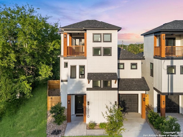 1310 S Mesquite, San Antonio, TX 78210 - contemporary home featuring a balcony, roof with shingles, concrete driveway, an attached garage, and board and batten siding