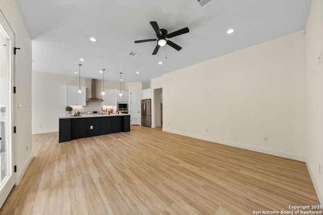 1310 S Mesquite, San Antonio, TX 78210 - unfurnished living room with a ceiling fan, light wood-type flooring, recessed lighting, and baseboards