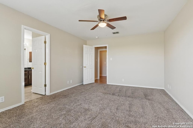 unfurnished bedroom featuring carpet flooring, baseboards, and a ceiling fan