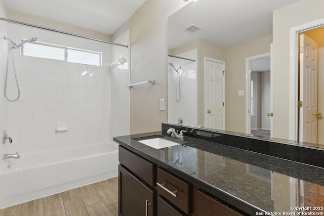 full bathroom featuring bathtub / shower combination, vanity, and wood finished floors