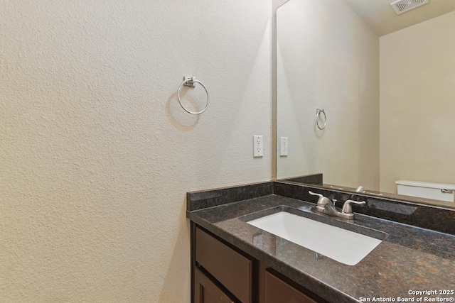 half bath with vanity and toilet