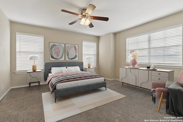 bedroom with multiple windows, carpet, a ceiling fan, and baseboards