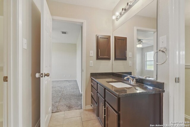 bathroom with vanity, a ceiling fan, tile patterned flooring, and baseboards