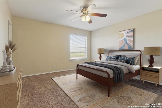 bedroom with carpet flooring, baseboards, and a ceiling fan