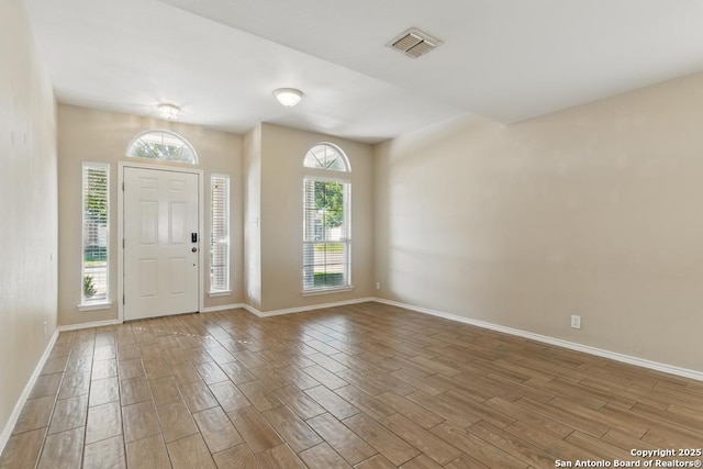 entrance foyer featuring wood finished floors and baseboards
