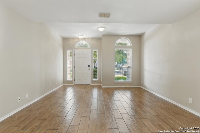 entryway with wood finished floors and baseboards