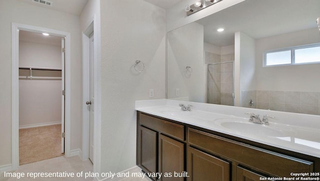 310 Steele Hbr, Cibolo, TX 78108 - bathroom featuring a tile shower, double vanity, a spacious closet, and tile patterned flooring