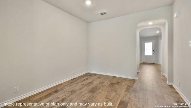 310 Steele Hbr, Cibolo, TX 78108 - unfurnished room featuring arched walkways, wood finished floors, and recessed lighting