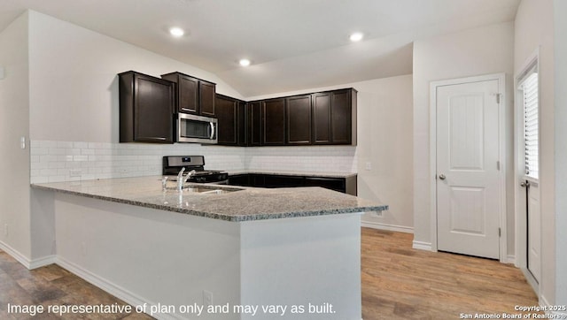 310 Steele Hbr, Cibolo, TX 78108 - kitchen with stainless steel appliances, decorative backsplash, light stone countertops, vaulted ceiling, and recessed lighting