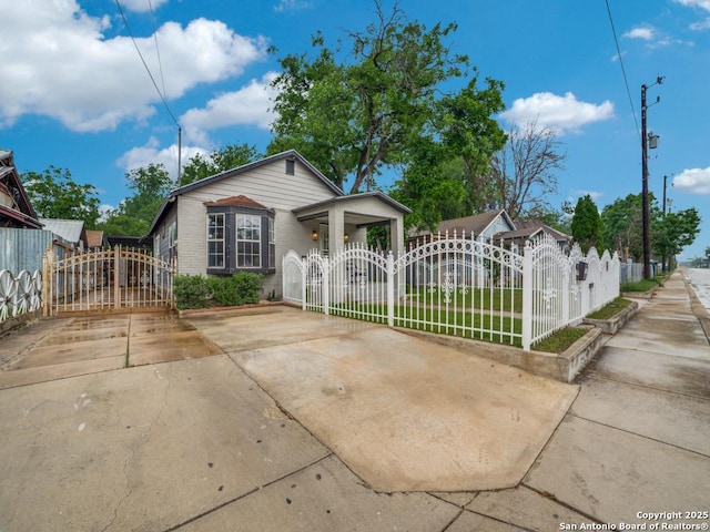 bungalow-style house with a gate and a fenced front yard