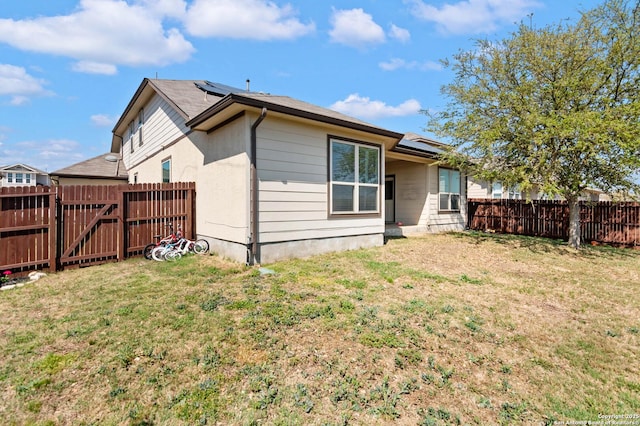 9870 Mulhouse, Schertz, TX 78154 - rear view of house with a gate and solar panels