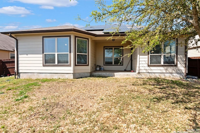 9870 Mulhouse, Schertz, TX 78154 - back of property with roof mounted solar panels, a patio, and metal roof