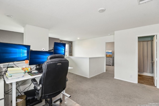 carpeted home office featuring baseboards