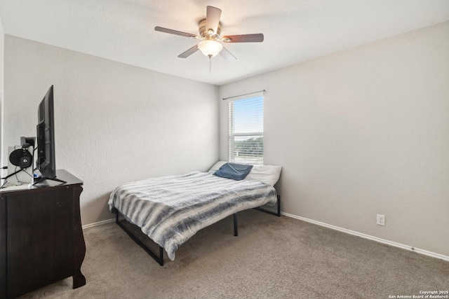 carpeted bedroom with baseboards and a ceiling fan