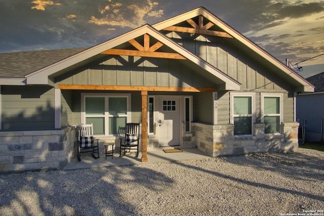 1139 Cedar Bnd, Canyon Lake, TX 78133 - view of front of house featuring board and batten siding, stone siding, and roof with shingles