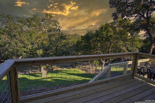 1139 Cedar Bnd, Canyon Lake, TX 78133 - deck at dusk featuring a yard